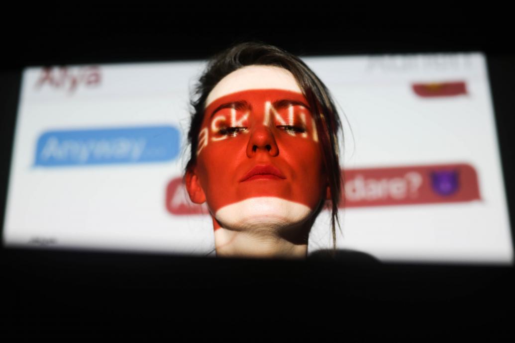 woman in front of a projected image